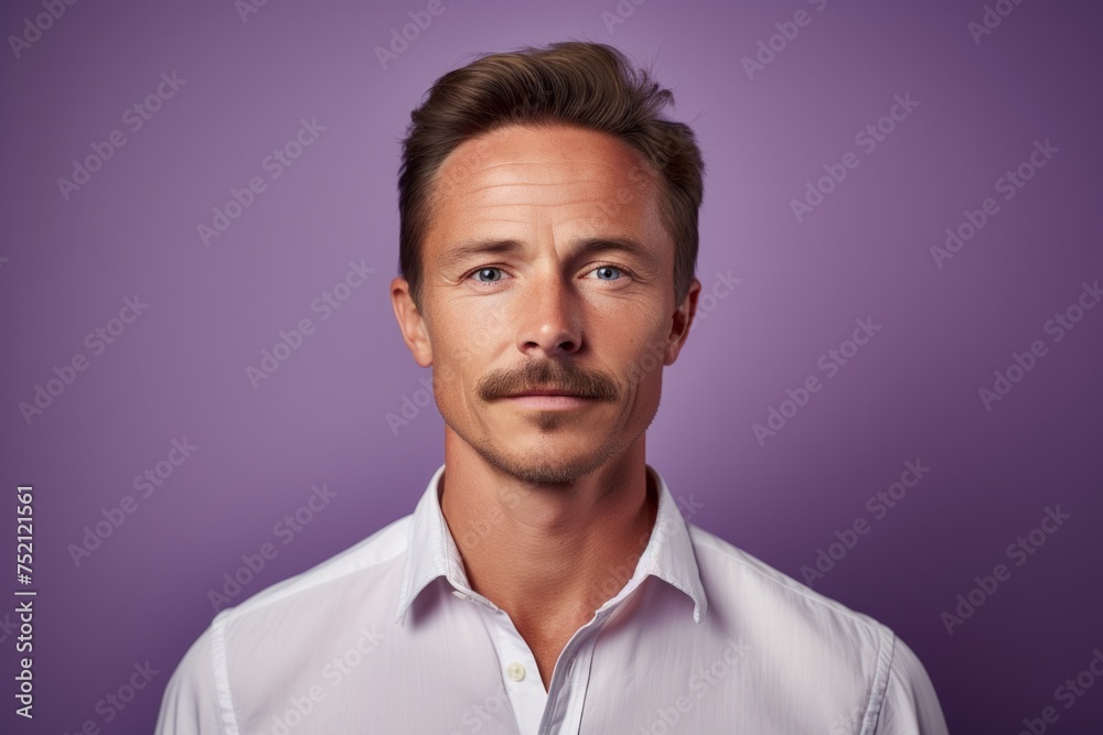 Portrait of a handsome young man in white shirt on purple background. Portrait of a handsome young man in white shirt on purple background.