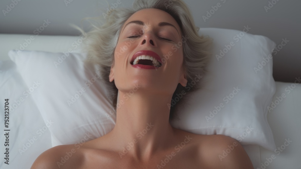 Woman's face during an orgasm in bed. Women's pleasure. A beautiful female with soft skin is enjoying and feels good. Woman's face during an orgasm in bed. Women's pleasure. A beautiful female with soft skin is enjoying and feels good.
