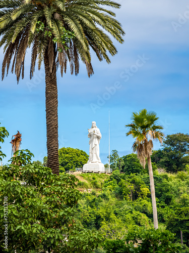 A caricature of the renowned Christ of Havana statue, Cristo de La Habana, depicted with a cigar in the right hand and a mojito in the left, paying homage to the popular Cuban culture and traditions. photo