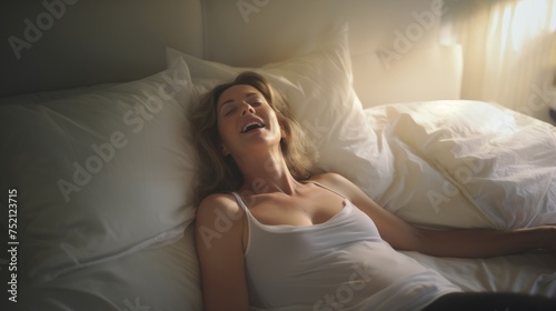 Woman's face during an orgasm in bed. Women's pleasure. A beautiful female with soft skin is enjoying and feels good.