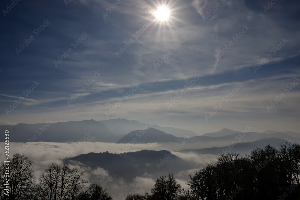 Fototapeta premium Mountain Peak Above Cloudscape in a Sunny Day in Lugano, Ticino in Switzerland.