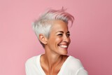 Portrait of happy middle aged woman with pink hair on pink background