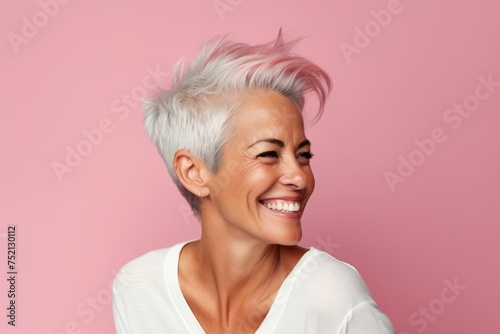 Portrait of happy middle aged woman with pink hair on pink background