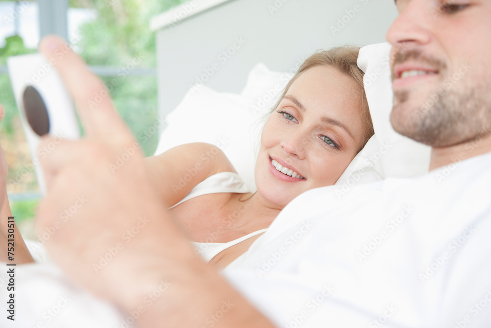 Couple in Bed Using Smartphone
