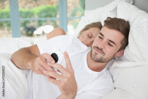 Man in Bed Using Smartphone
 photo