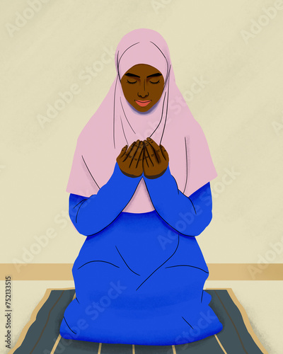 Muslim woman in hijab praying on mat
