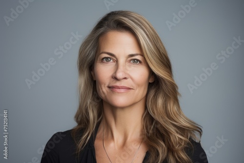 Portrait of a beautiful middle aged businesswoman, isolated on grey background
