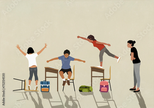 Angry school teacher watching unruly, hyper schoolchildren jumping on desks in classroom
 photo