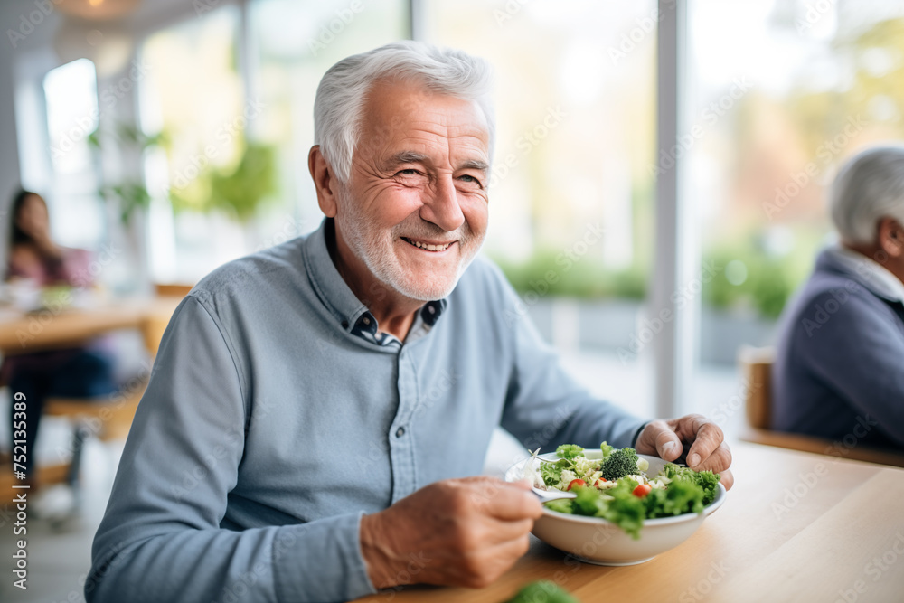 An elderly man in a retirement facility joyfully indulges in a nutritious lunch, reflecting a lifestyle of health and satisfaction An elderly man in a retirement facility joyfully indulges in a nutritious lunch, reflecting a lifestyle of health and satisfaction