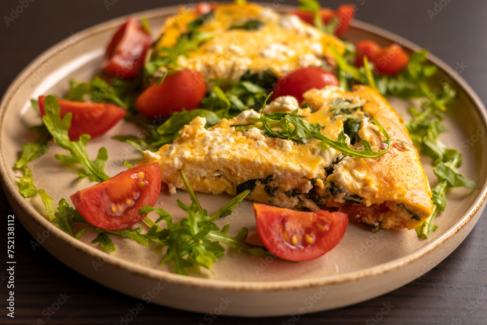 delicious spring frittata for a perfect brunch with arugula and cherry tomatoes close-up delicious spring frittata for a perfect brunch with arugula and cherry tomatoes close-up