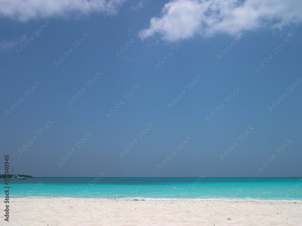 Turquoise sea water and blue sky on a beach in Little Exuma Island, Bahamas.