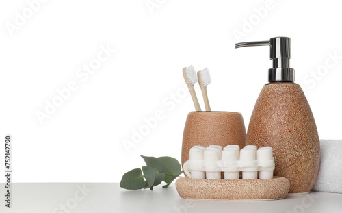 Bath accessories. Different personal care products and eucalyptus branch on table against white background. Space for text