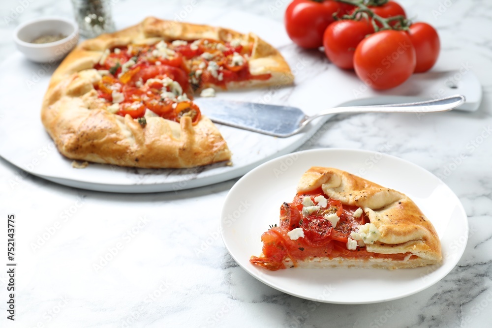 Tasty galette with tomato and cheese (Caprese galette) on white marble table, closeup Tasty galette with tomato and cheese (Caprese galette) on white marble table, closeup