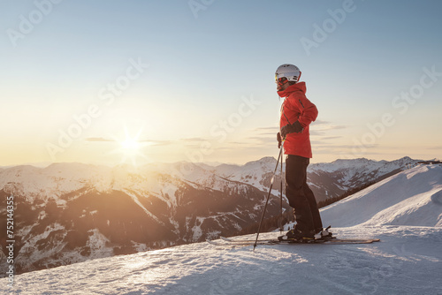 Male skier wiatching the sunset  in the mountains
