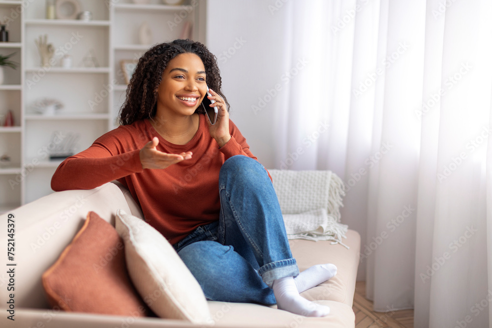 Pleasant Chat. Happy Young Black Woman Talking On Cellphone At Home Pleasant Chat. Happy Young Black Woman Talking On Cellphone At Home