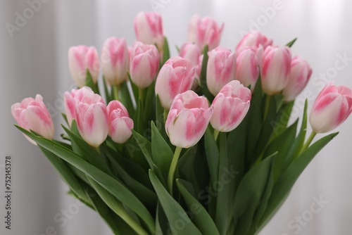 Beautiful bouquet of fresh pink tulips on blurred background, closeup