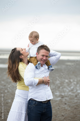 Young Family together on beach.