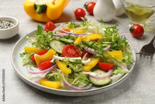 Tasty fresh vegetarian salad on grey table, closeup