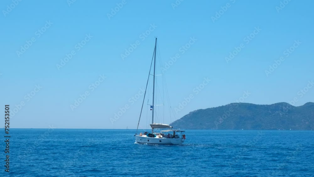 Floating journey yacht across lagoon. A white speed luxury yacht with no sails floating in the deep sea across tropical lagoon in the sun rays in summer. Floating journey yacht across lagoon. A white speed luxury yacht with no sails floating in the deep sea across tropical lagoon in the sun rays in summer.