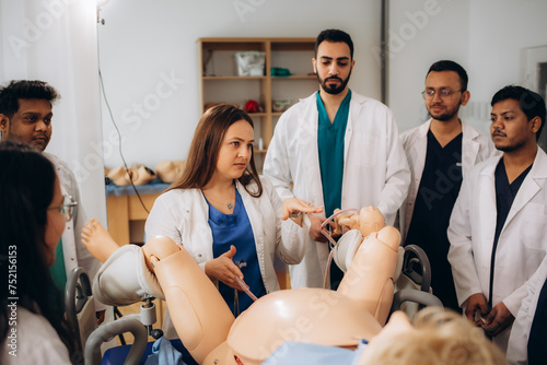 Students of the gynecology faculty practice giving birth using a mannequin