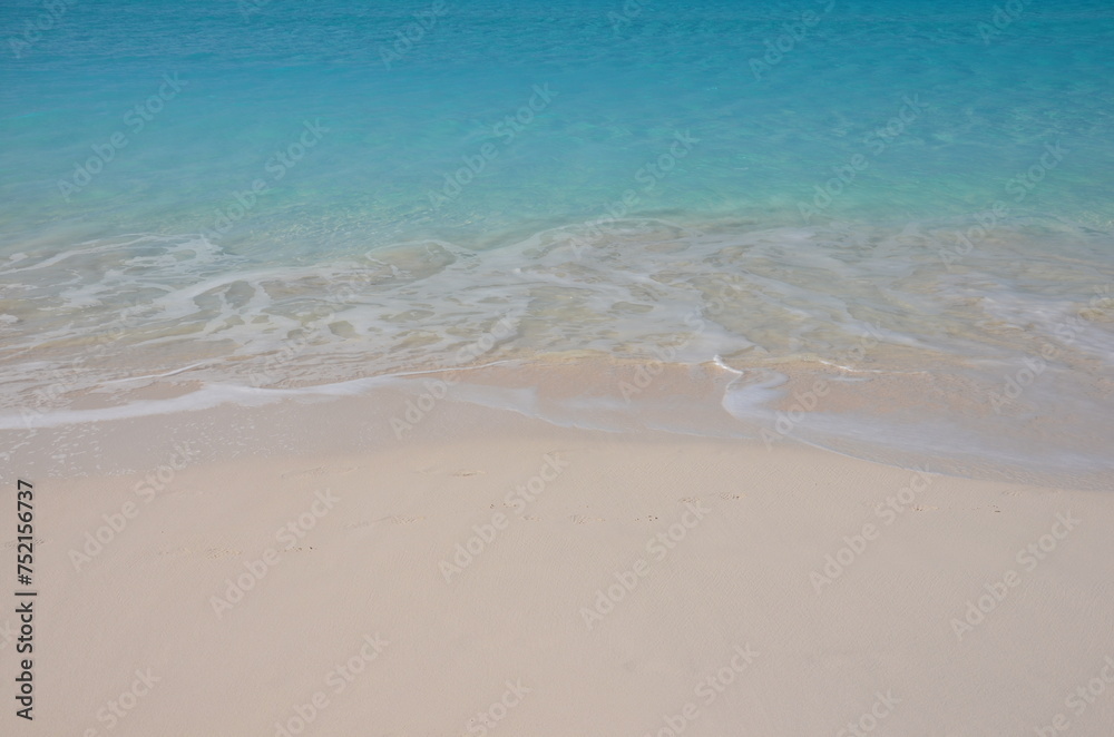 Soft blue ocean wave or clear sea on clean sandy beach 