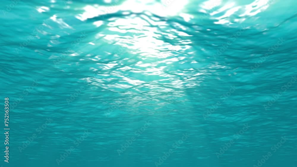 Underwater loop background animation. Light rays shining through ocean surface.