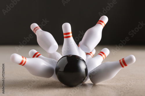 Bowling strike hit on dark background. Minimal concept of success and win.