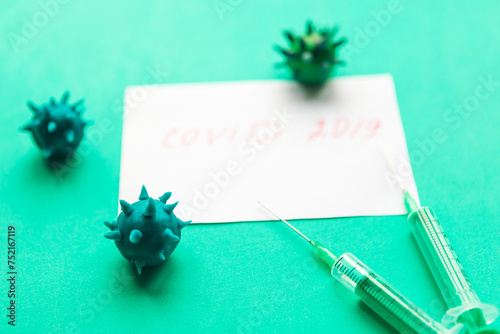 Disposable syringes and white mockup blank on green background. Chinese Coronavirus disease COVID-19