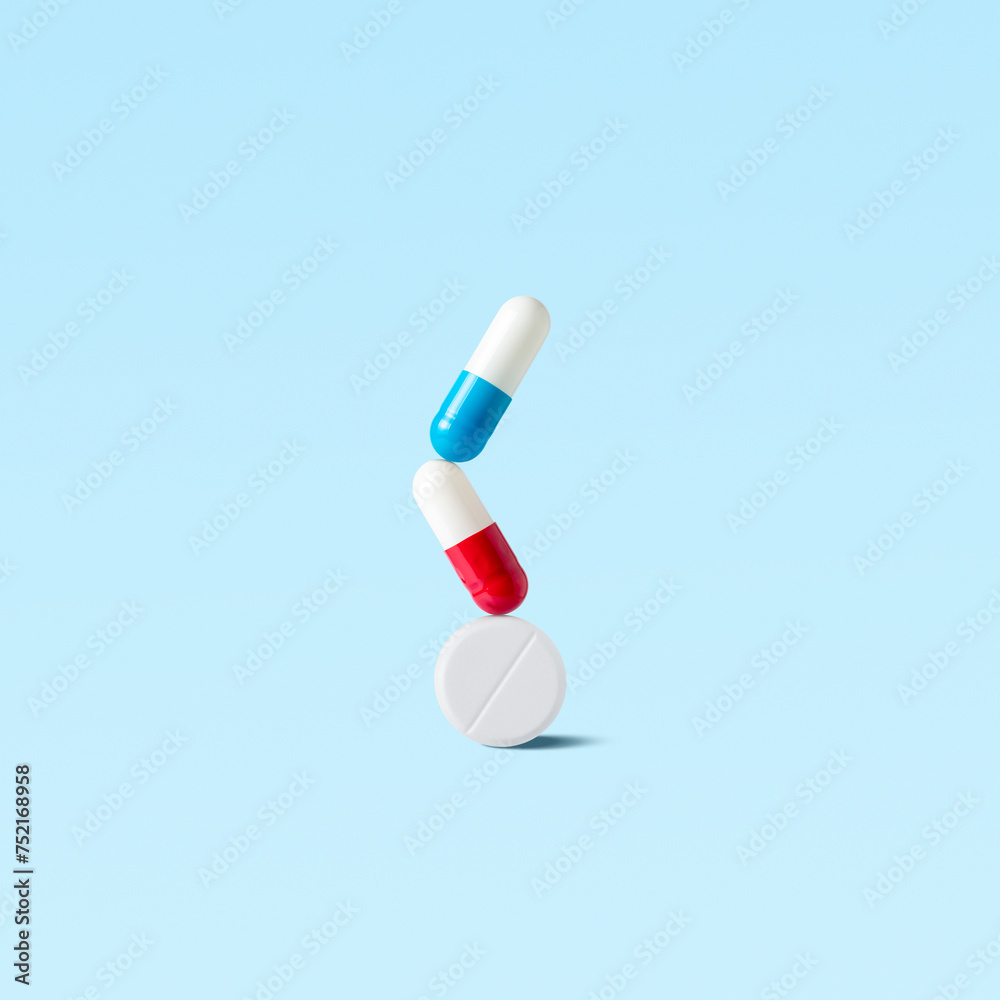 Creative layout of pills on blue background. Minimal pharmacy concept. Creative layout of pills on blue background. Minimal pharmacy concept.