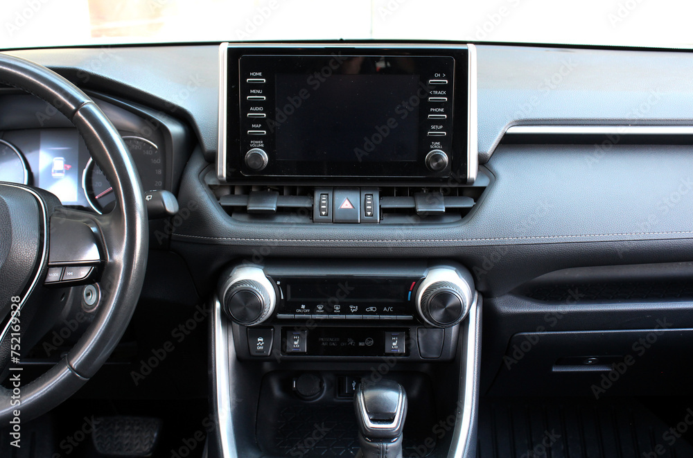 Modern SUV dashboard. Screen multimedia system. Interior of a modern luxury car. Control panel in a modern SUV. Car climate control close up. 