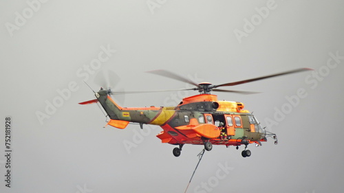 exhibition helicopter rescue orange base torrejon propellers background gray sky photo