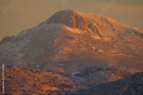 mountain with snow on the summit at dawn sierra nevada andalucia tourism ski orange light photo