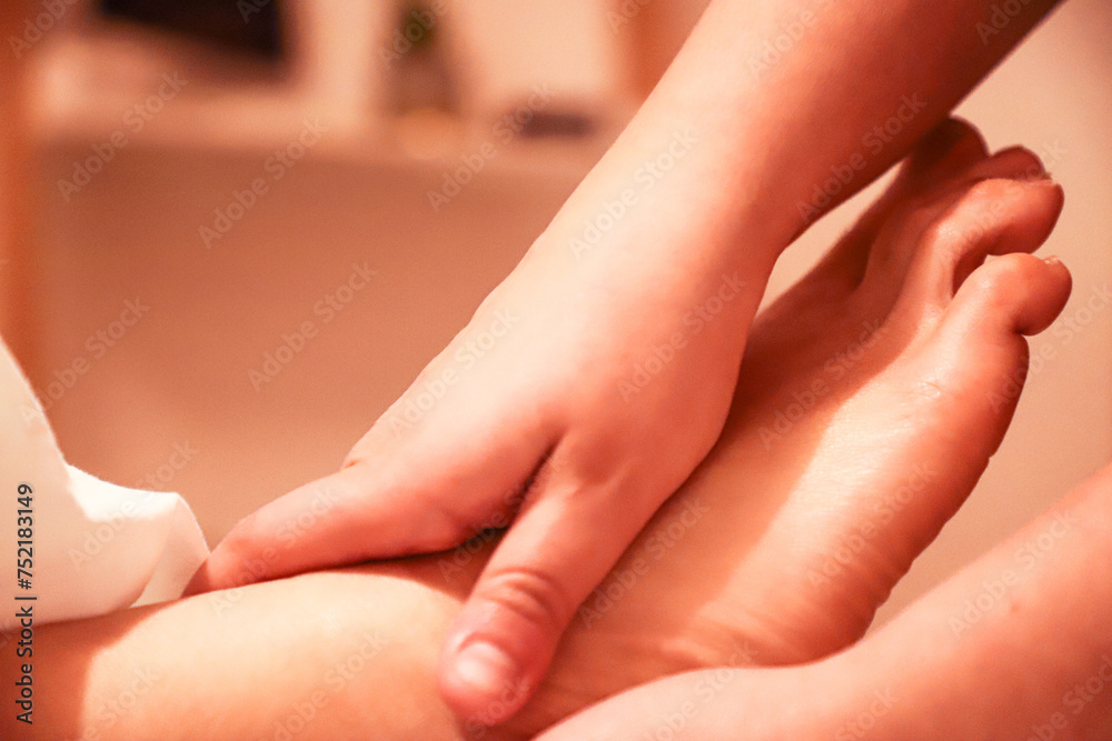 Fototapeta premium Masseur providing a foot massage to a client.