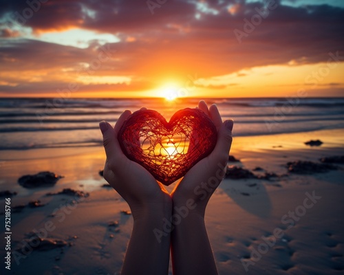 A romantic beach sunset with a heartshaped hand silhouette conveying loves warmth and tenderness
