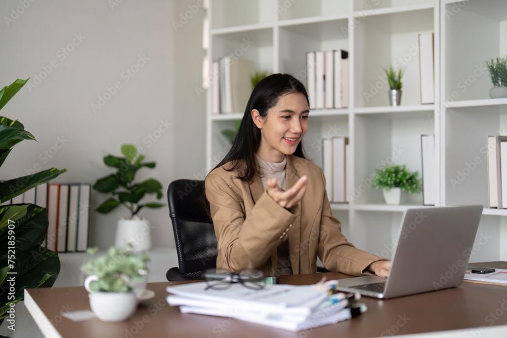 Work from home. Businesswoman using laptop computer in her room. Eco friendly businesswoman working on desk, freelance, green room area, sustainable lifestyle concept Work from home. Businesswoman using laptop computer in her room. Eco friendly businesswoman working on desk, freelance, green room area, sustainable lifestyle concept