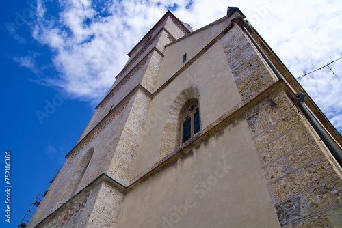 Looking up bell tower of catholic St. Kancijan’s Church at the old town of Kranj on a sunny summer day. Photo taken August 10th, 2023, Kranj, Slovenia. photo