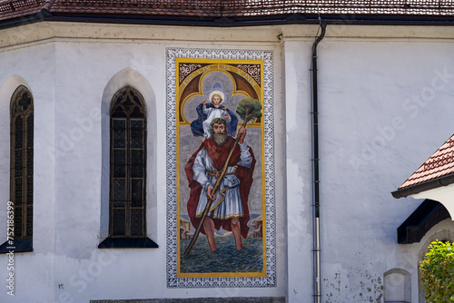 Facade of catholic Church of St. Sebastian, Fabian and Roch at Pungart with colorufl painting at the old town of Kranj on a sunny summer day. Photo taken August 10th, 2023, Kranj, Slovenia. photo