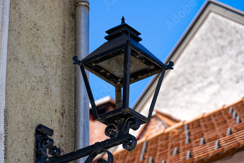 Old town of Slovenian City of Kranj with close-up of black lantern on a sunny summer day. Photo taken August 10th, 2023, Kranj, Slovenia. photo