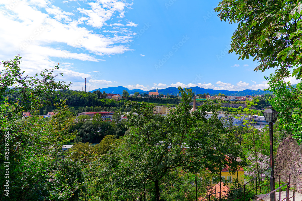 Beautiful view with woodland and residential houses in the background at Slovenian City of Kranj on a sunny summer day. Photo taken August 10th, 2023, Kranj, Slovenia.