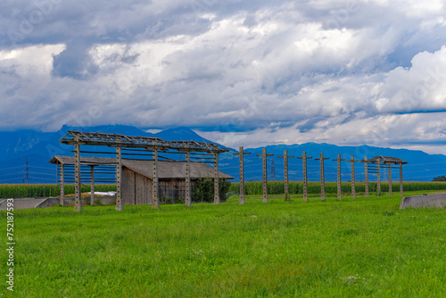 Wrecked hayrack with wooden barn at farmland at village of Zabnica on a blue cloudy summer evening. Photo taken August 10th, 2023, Zabnica, Kranj, Slovenia.