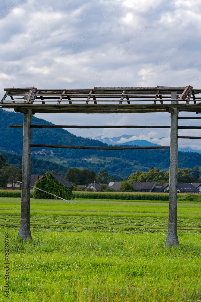 Scenic view of hay rack at farmland at village of Zabnica on a blue cloudy summer evening. Photo taken August 10th, 2023, Zabnica, Kranj, Slovenia.