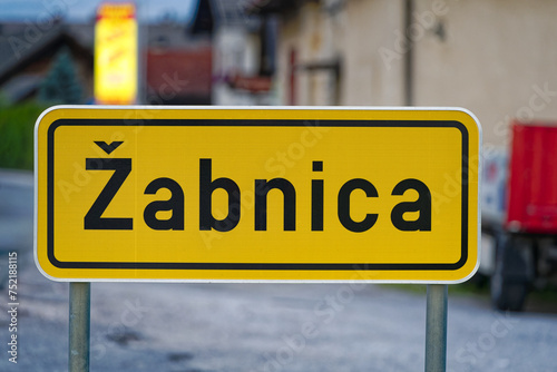 Wallpaper Mural Close-up of yellow and black road sign at rural village of Zabnica on a cloudy summer evening. Photo taken August 10th, 2023, Žabnica, Kranj, Slovenia. Torontodigital.ca