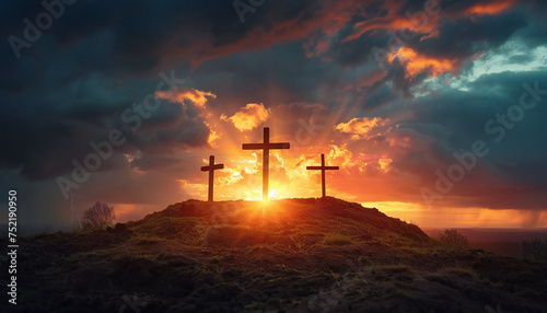 Recreation of three wood cross in a hill at sunset photo