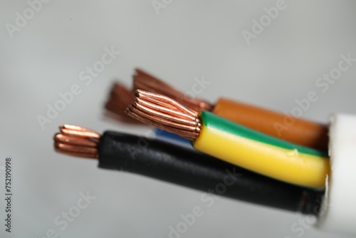Fototapeta Naklejka Na Ścianę i Meble -  Colorful electrical wire on gray background, closeup