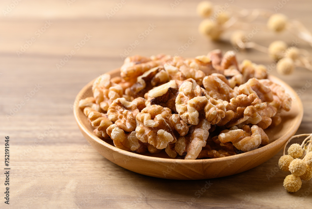 Organic raw walnuts in wooden plate, Food ingredient Organic raw walnuts in wooden plate, Food ingredient