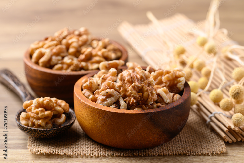 Organic raw walnuts in wooden bowl, Food ingredient Organic raw walnuts in wooden bowl, Food ingredient