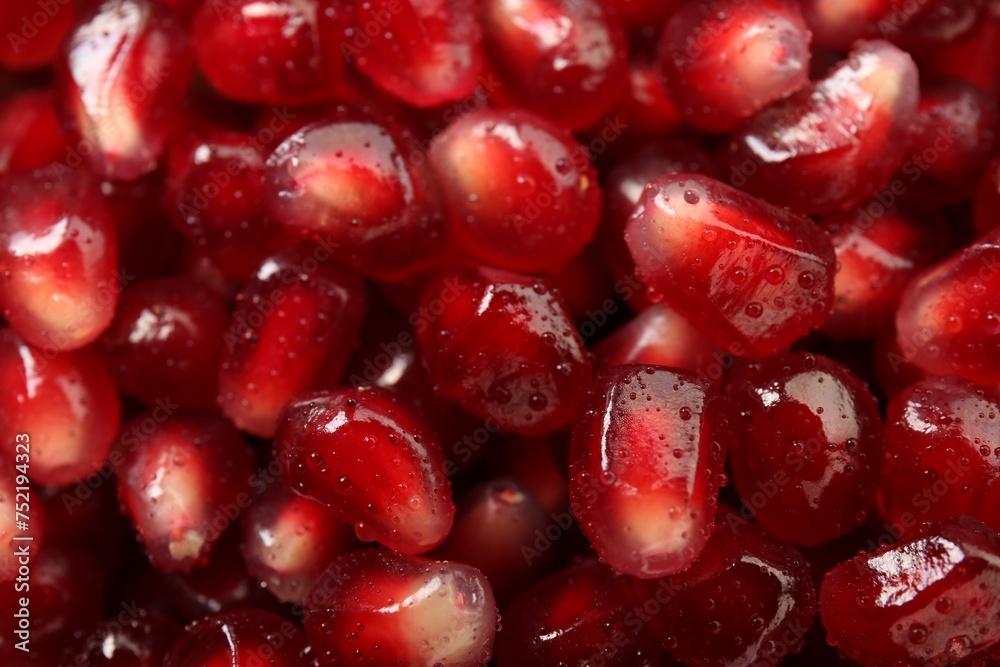 Ripe juicy pomegranate grains with water drops as background, top view Ripe juicy pomegranate grains with water drops as background, top view