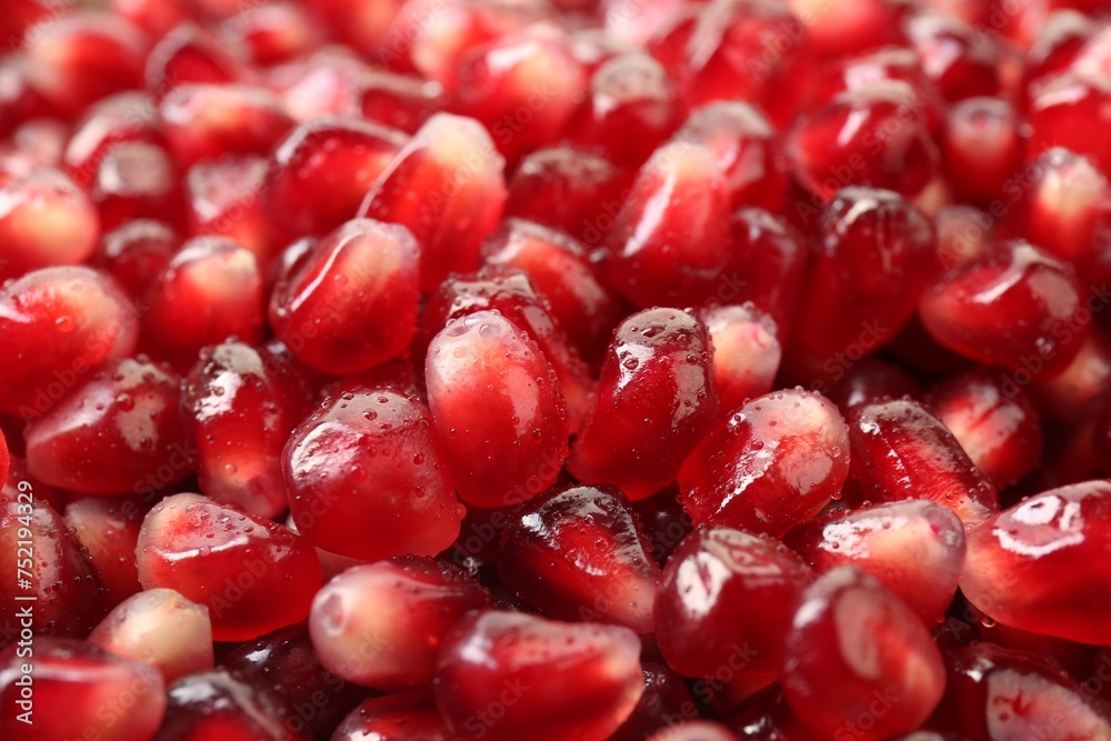 Ripe juicy pomegranate grains with water drops as background, closeup Ripe juicy pomegranate grains with water drops as background, closeup