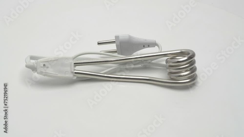 Immersion water heater for travel rotates on a white background.