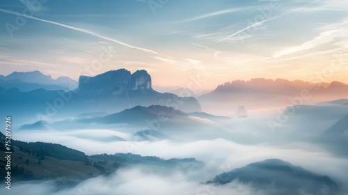 Panoramic view of the mountains in the fog at sunrise.